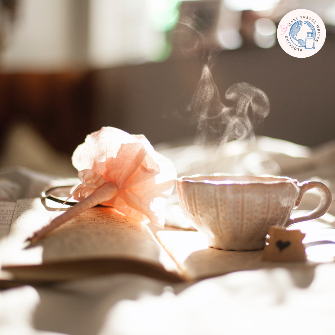 A Cup of hot drink, A Notebook and a flower-shaped pen.